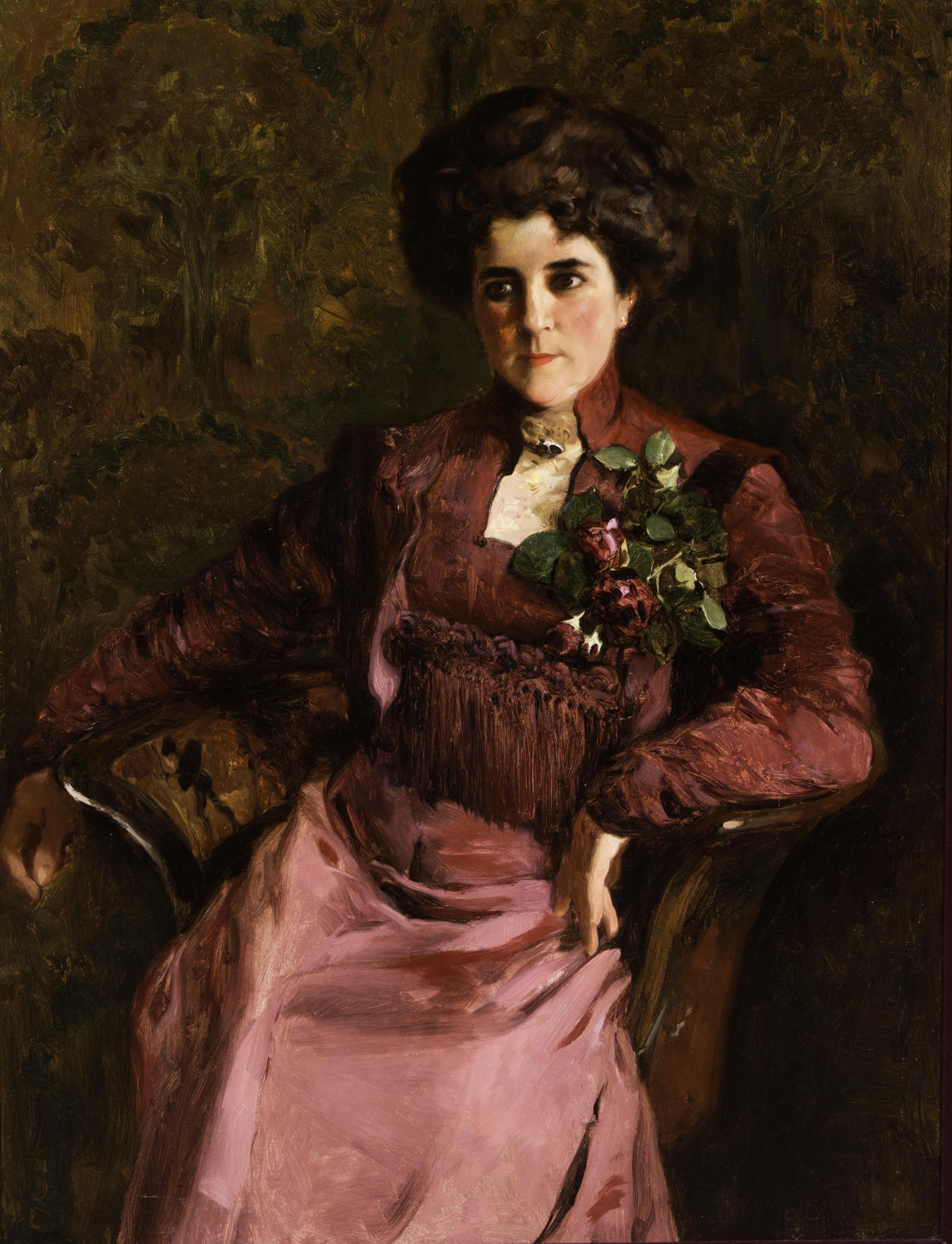 Portrait of a woman sitting in a chair.