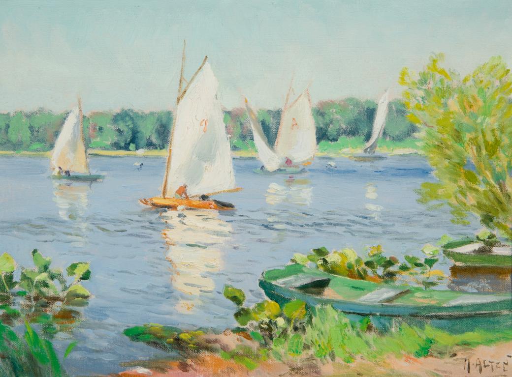 Four white sailboats in water, trees in the distance.