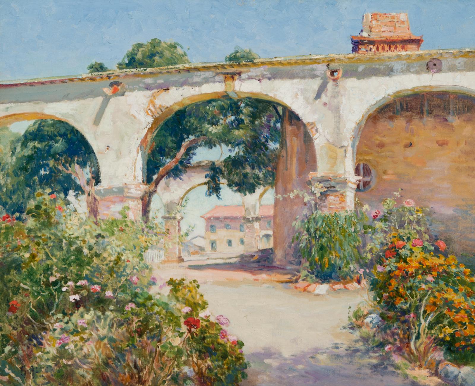 White arches with brick buildings behind them.