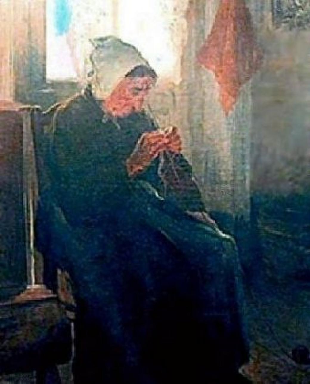 Image of an older woman wearing black with a white cap, sitting in a chair knitting.