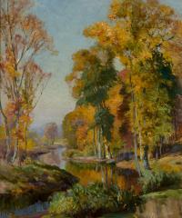 Yellow, orange, and green colored trees along the banks of a stream.