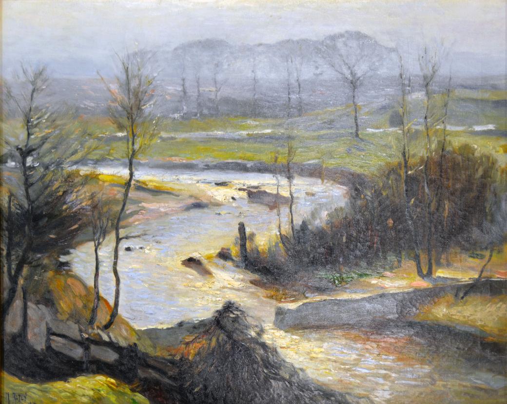 Slightly elevated view of a winding river with a dam.