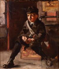 Little boy dressed in all black with a white bag slung over his shoulder sits on a crate.