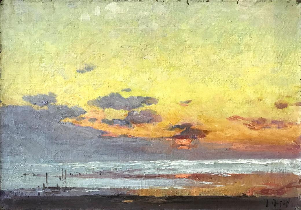 Water scene at sunset, blue water with yellows, pinks and oranges in the sky.