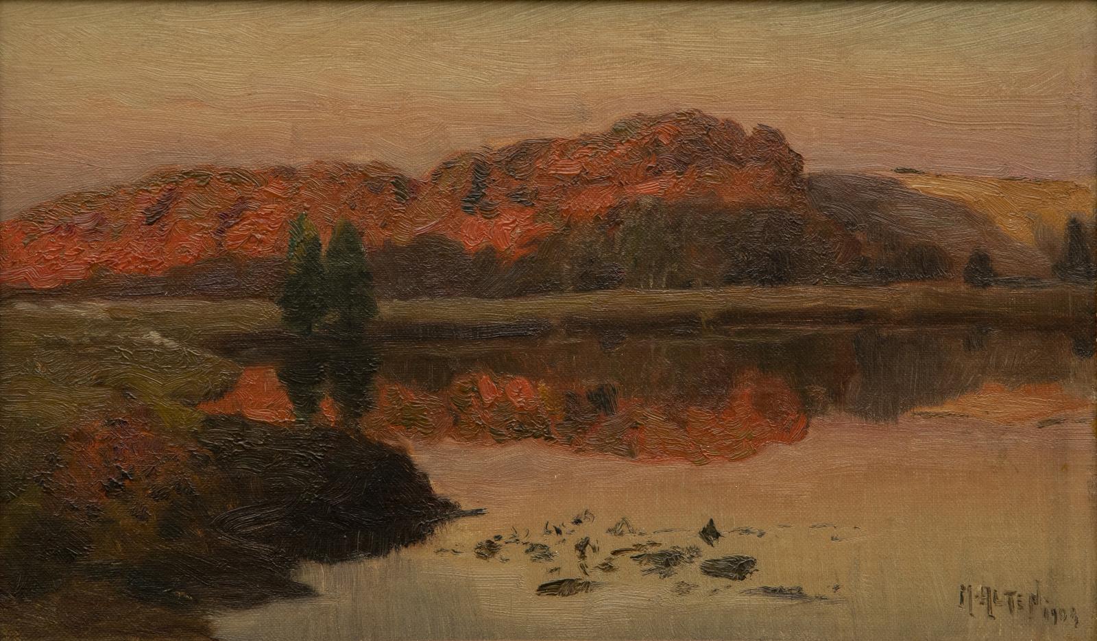 Side of a mountains brushed red with the setting sun, reflecting in water below.