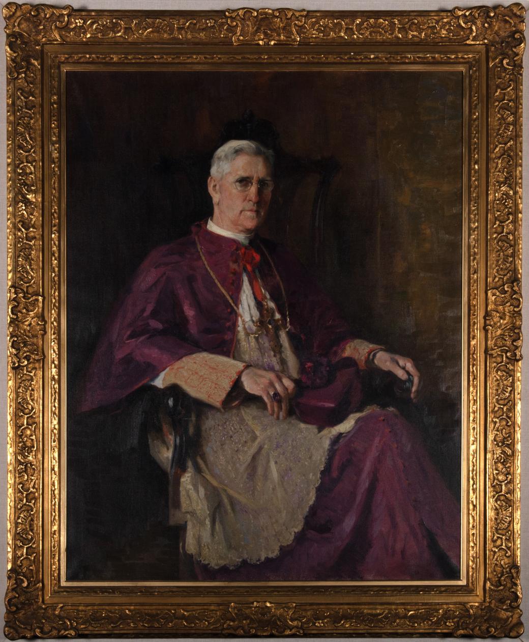 A painting of Bishop Kelly wearing a white and purple cassock and alb.