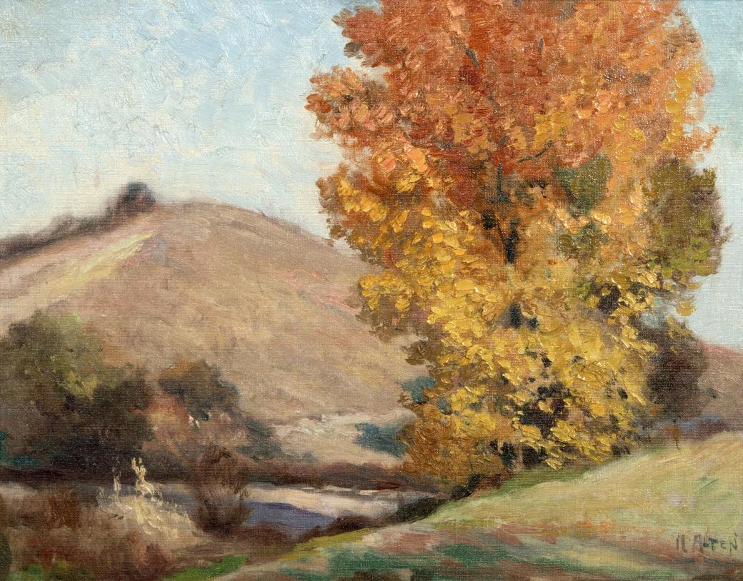 Tan hills with orange and yellow tree.