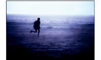 Ethiopian Refugee Running in Rainstorm, Togwajaale, Somalia