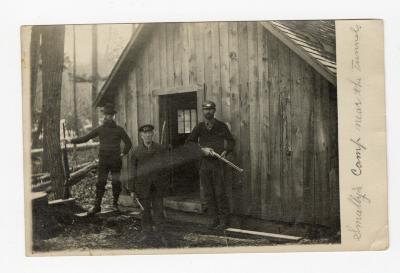 Untitled (Three Men Next to Wooden Building) 