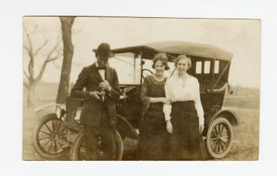 Untitled (Two Woman and Man next to Car) 