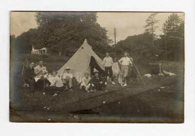 Untitled (Young Men near Tent at Table) 