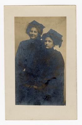 Untitled (Two women wearing dark robes and hats)